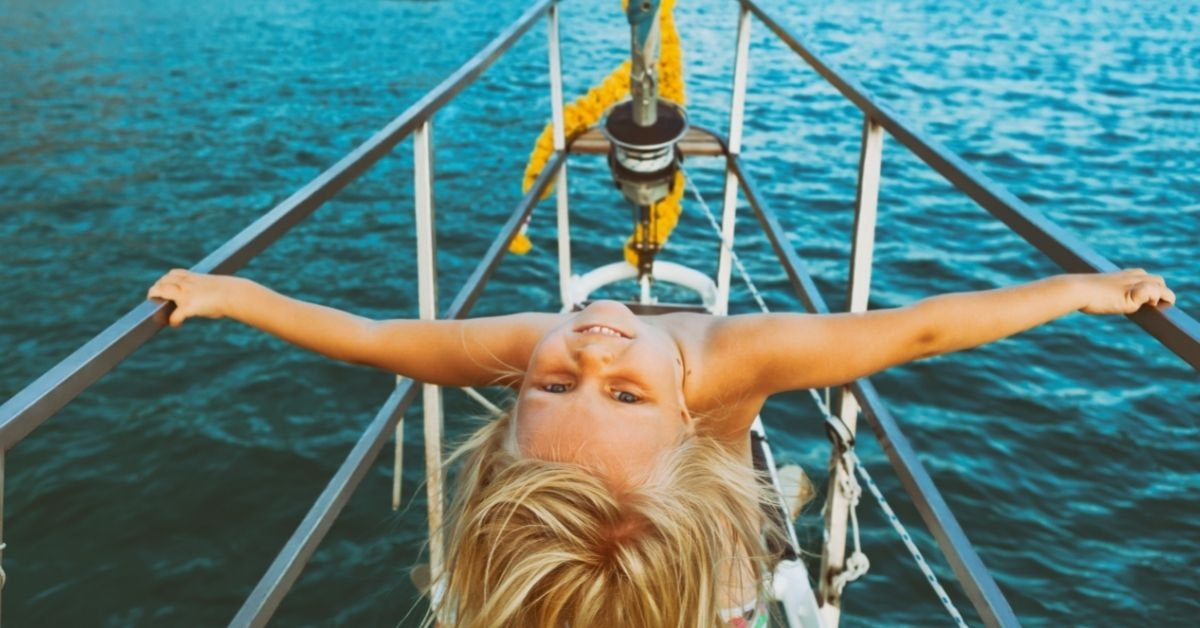 A child upside down on a boat

Description automatically generated with low confidence